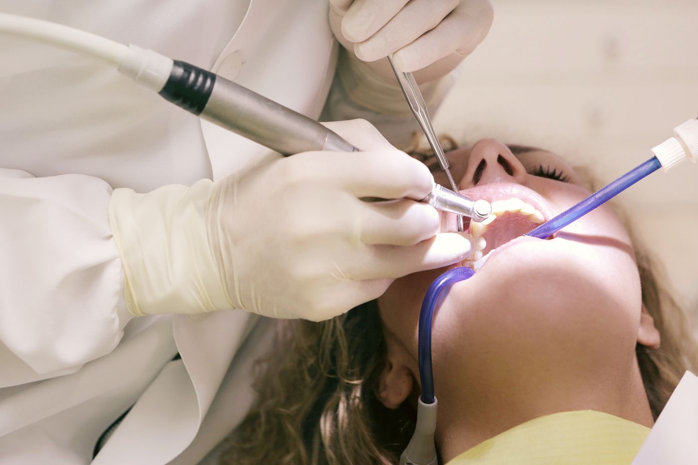 A dentist gently treating a patient's teeth in our office